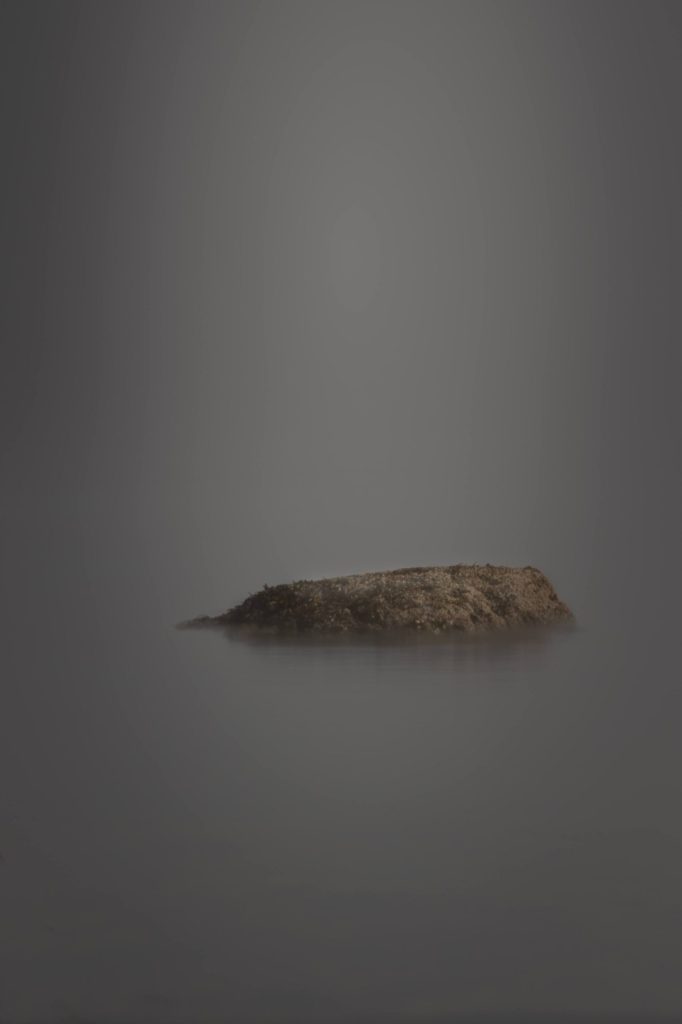 minimalist photography, solitary rock as low tide long exposure